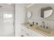Modern bathroom boasts double sinks, sleek fixtures, and a glass-enclosed shower at 312 E Windsor Ave # 3, Phoenix, AZ 85004