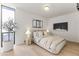 Cozy bedroom features a large window with potted tree and stylish modern decor at 312 E Windsor Ave # 3, Phoenix, AZ 85004