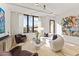 Bright living room with a curved sofa, stylish decor, and large windows with natural light at 312 E Windsor Ave # 3, Phoenix, AZ 85004