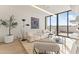 Bright living room with modern furnishings, plush seating, and floor-to-ceiling sliding glass doors to the balcony at 312 E Windsor Ave # 3, Phoenix, AZ 85004