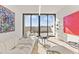Cozy living area with soft white sofa, colorful artwork, and access to the balcony with expansive views at 312 E Windsor Ave # 3, Phoenix, AZ 85004