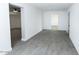 A bright open living room with tile flooring and white walls leads to a smaller room with a mini-split at 3128 N 40Th Ave, Phoenix, AZ 85019