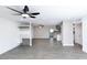 Bright living room with gray floors, ceiling fan, and open concept layout flowing into a modern kitchen at 3128 N 40Th Ave, Phoenix, AZ 85019