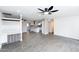 Open living room with modern gray flooring, ceiling fans, and natural light flowing into the kitchen at 3128 N 40Th Ave, Phoenix, AZ 85019