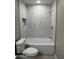 Bright bathroom showcasing a shower-tub combo with white marble tile at 3314 W Del Monico Ln, Phoenix, AZ 85051