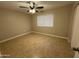 Bedroom with tile flooring, neutral colors, fan, and a bright window at 3314 W Del Monico Ln, Phoenix, AZ 85051