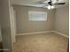 Bedroom featuring tile flooring, neutral colors, fan, closet and a bright window at 3314 W Del Monico Ln, Phoenix, AZ 85051