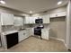 Modern kitchen featuring white cabinets, stainless steel appliances, and tile flooring at 3314 W Del Monico Ln, Phoenix, AZ 85051