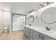Stylish bathroom featuring a double vanity, modern lighting, and a sleek glass shower at 332 N Cobblestone St, Gilbert, AZ 85234