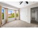 This bedroom has a ceiling fan, carpeted floors, a large window with a view and a closet at 332 N Cobblestone St, Gilbert, AZ 85234