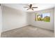 Cozy bedroom with neutral carpet, ceiling fan, window with curtains, and neutral walls at 332 N Cobblestone St, Gilbert, AZ 85234
