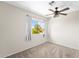 Bright bedroom featuring a ceiling fan, neutral walls, plush carpet, and a window view at 332 N Cobblestone St, Gilbert, AZ 85234