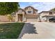 Charming two-story home with a red tile roof, a well-kept lawn, and a spacious driveway at 332 N Cobblestone St, Gilbert, AZ 85234