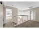 Carpeted hallway with white iron railing and open doorways at 332 N Cobblestone St, Gilbert, AZ 85234