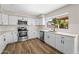Well-lit kitchen features stainless steel appliances, white cabinets, and subway tile backsplash at 332 N Cobblestone St, Gilbert, AZ 85234