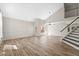 Spacious living room with vaulted ceiling, wood-look tile flooring, modern staircase, and ample natural light at 332 N Cobblestone St, Gilbert, AZ 85234