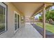 Covered patio overlooking a landscaped backyard with lush greenery and sunny skies at 332 N Cobblestone St, Gilbert, AZ 85234