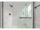 This primary bathroom features a luxurious glass shower with black hardware and marble tiling at 332 N Cobblestone St, Gilbert, AZ 85234