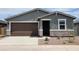 Charming single-story home featuring a brown garage door, stone accents, and a well-maintained front yard at 3582 E Audrey Dr, San Tan Valley, AZ 85143