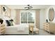 Bright bedroom featuring stylish decor, ample natural light, and modern light fixture at 36570 W Maddaloni Ave, Maricopa, AZ 85138