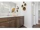 Modern bathroom featuring a double vanity with sleek countertops, stylish accents, and ample storage space at 46392 W Lander Ln, Maricopa, AZ 85139
