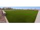 Expansive community green space with lush grass and playground, ideal for outdoor activities and Gathering fun at 46392 W Lander Ln, Maricopa, AZ 85139