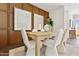Dining area with wood table, stylish seating, and decorative wall art at 46392 W Lander Ln, Maricopa, AZ 85139