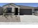 Charming single-story home featuring a two-car garage and low-maintenance desert landscaping at 46392 W Lander Ln, Maricopa, AZ 85139