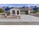 Charming single-story home with a two-car garage and desert landscaping against a beautiful mountain backdrop at 46392 W Lander Ln, Maricopa, AZ 85139