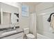 Well-lit bathroom featuring a shower-tub combo, a granite countertop and a large mirror at 46395 W Lander Ln, Maricopa, AZ 85139