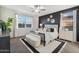 Modern bedroom featuring a black accent wall, ceiling fan, and large windows for ample natural light at 46395 W Lander Ln, Maricopa, AZ 85139
