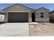 Charming single-story home with a two-car garage and neutral-colored stucco exterior at 46395 W Lander Ln, Maricopa, AZ 85139