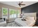 Bright bedroom featuring a ceiling fan, large windows, and a comfortable bed with stylish linens at 4777 S Fulton Ranch Blvd # 1032, Chandler, AZ 85248