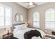 Cozy bedroom with plantation shutters, a ceiling fan, a stylish bed, and a unique mirror at 4777 S Fulton Ranch Blvd # 1032, Chandler, AZ 85248