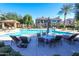 Resort-style community pool area with ample lounge chairs, umbrellas, a covered gazebo, and lush landscaping at 4777 S Fulton Ranch Blvd # 1032, Chandler, AZ 85248