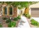 Home exterior with a walkway leading to the entrance, complemented by manicured landscaping and attached garage at 4777 S Fulton Ranch Blvd # 1032, Chandler, AZ 85248