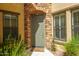 Welcoming front door with stone archway, complemented by lush greenery and windows with shutter accents at 4777 S Fulton Ranch Blvd # 1032, Chandler, AZ 85248