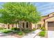 Charming home exterior with stone accents, arched windows, lush landscaping, and a well-maintained lawn at 4777 S Fulton Ranch Blvd # 1032, Chandler, AZ 85248