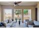 Inviting covered patio with neutral toned seating, a ceiling fan, and views of lush greenery and desert landscape at 4777 S Fulton Ranch Blvd # 1032, Chandler, AZ 85248