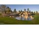 Scenic Fulton Ranch entrance featuring a stone waterfall and lush green lawn, perfect for relaxation at 4777 S Fulton Ranch Blvd # 1032, Chandler, AZ 85248
