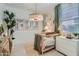 Adorable Bedroom with decorative wallpaper, stylish light fixture, and modern furniture at 4975 S 233Rd Dr, Buckeye, AZ 85326
