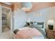 Inviting bedroom features white walls, complemented by peach trim, and a woven light fixture adding subtle texture at 4975 S 233Rd Dr, Buckeye, AZ 85326
