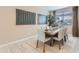 Stylish dining room with a modern table, comfortable seating, decorative artwork, and a serene ambiance at 4975 S 233Rd Dr, Buckeye, AZ 85326