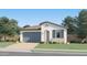 Charming single-story home with a two-car garage, stucco siding, and a tile roof surrounded by lush landscaping at 4975 S 233Rd Dr, Buckeye, AZ 85326