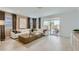 Bright and airy living room with a comfortable sofa, modern coffee table, and a sliding door to the outdoor patio at 4975 S 233Rd Dr, Buckeye, AZ 85326