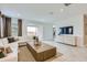 Spacious living room featuring a cozy sofa, a stylish coffee table, and a contemporary entertainment center at 4975 S 233Rd Dr, Buckeye, AZ 85326