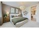Beautiful primary bedroom featuring stylish lighting, decor, and ensuite bathroom at 4975 S 233Rd Dr, Buckeye, AZ 85326