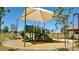 A playground offers a slide, shade, and climbing equipment for the community at 5210 W Top Hand Trl, Laveen, AZ 85339