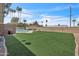 Wide backyard featuring artificial turf, a private pool, lounge furniture, and barbecue at 530 E Draper St, Mesa, AZ 85203