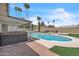 Backyard features a pool, hot tub, artificial turf, fire pit, and covered patio at 530 E Draper St, Mesa, AZ 85203